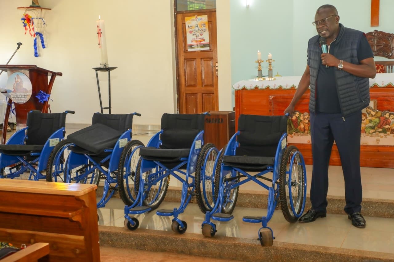 Donating wheelchairs to elders at Mundika catholic Parish